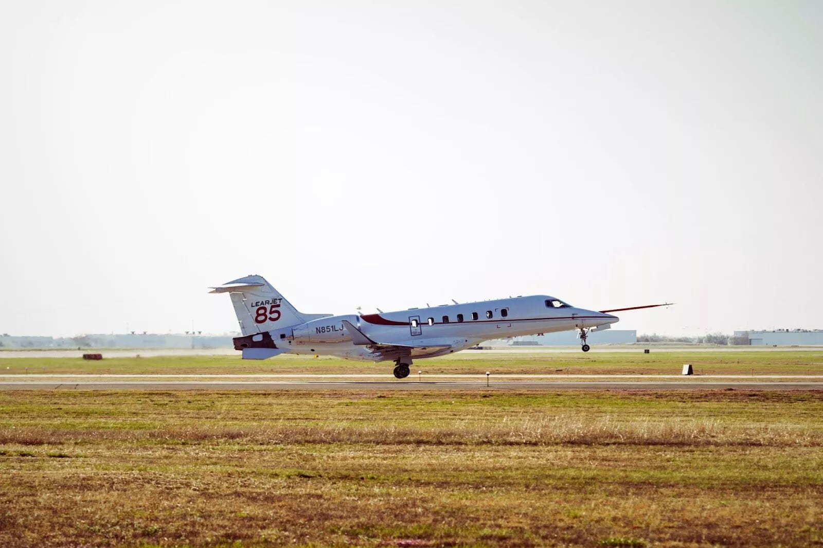 The sleek and sophisticated Bombardier Learjet 85, poised for takeoff, offers passengers a perfect blend of performance, luxury, and cutting-edge technology in the world of private aviation