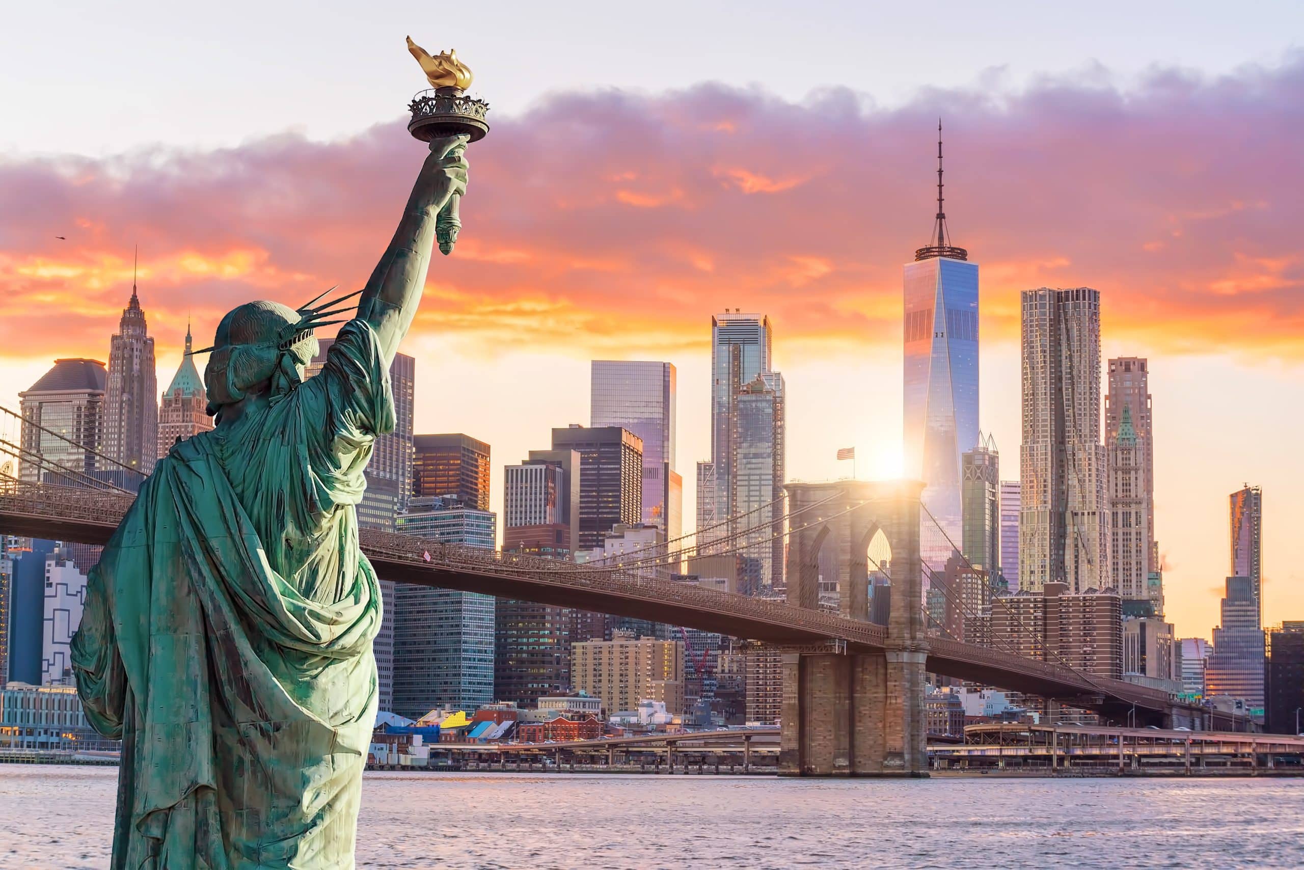 The iconic Statue of Liberty stands tall against the New York City skyline, symbolizing freedom and welcoming visitors to a premier private jet destination in the United States
