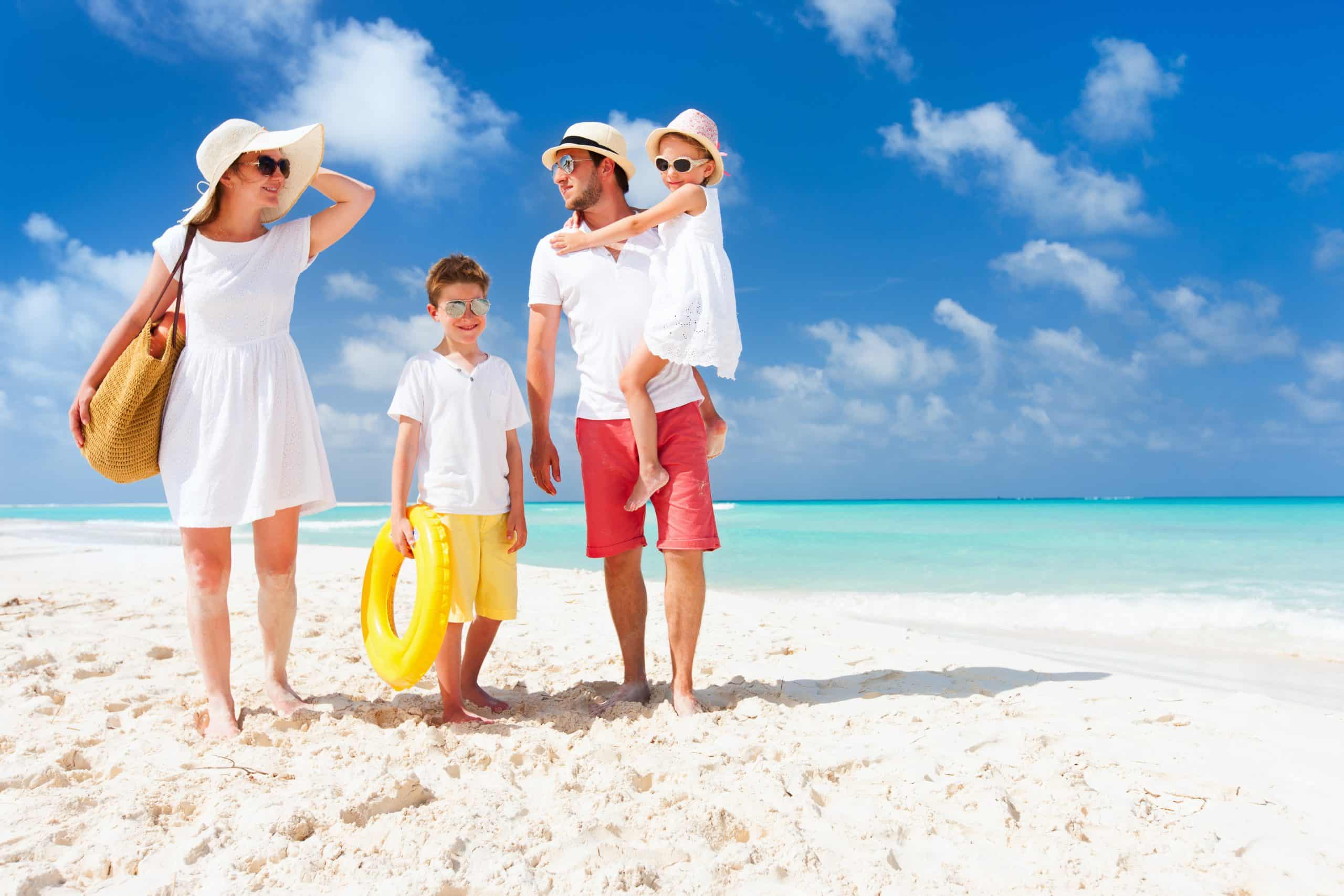 Joyful family enjoying a pristine tropical beach vacation in the US Virgin Islands, a sought-after private jet destination for unforgettable moments and sun-kissed memories