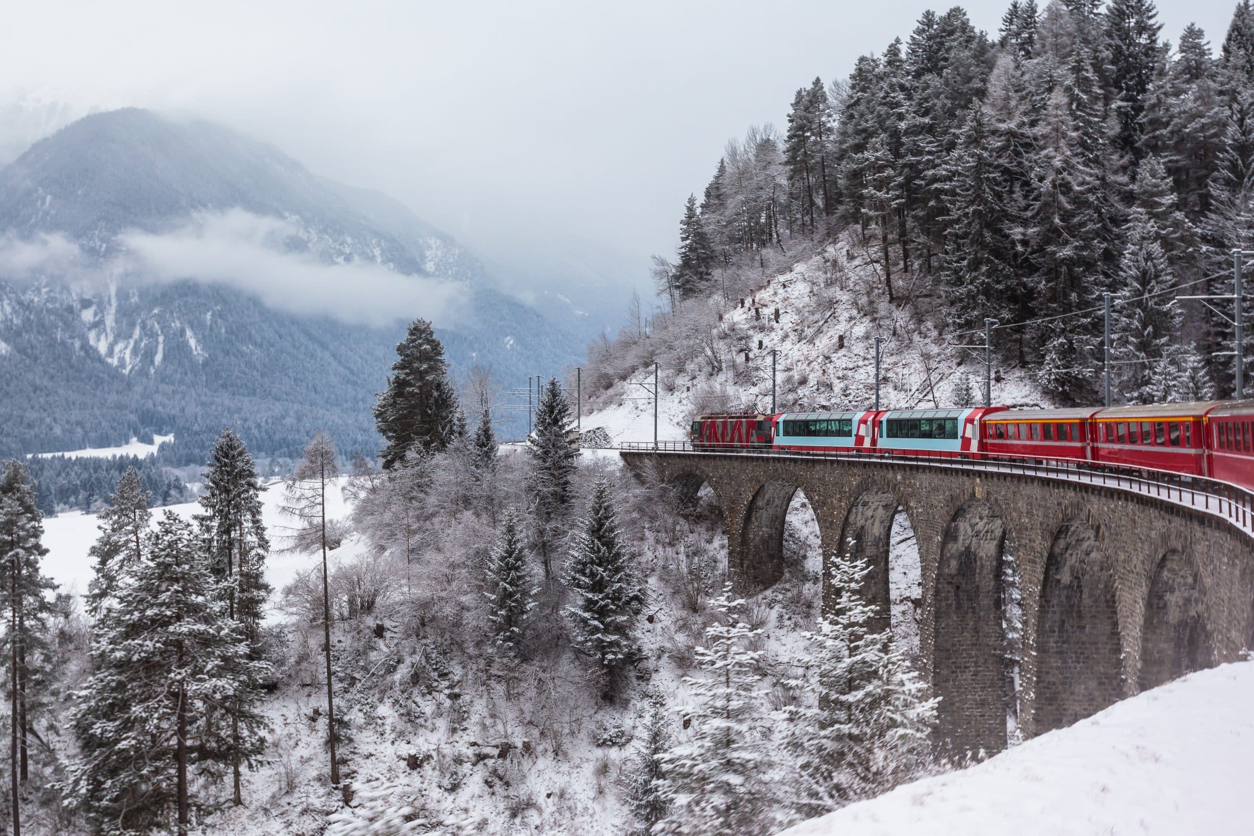 Experience the breathtaking journey on the Glacier Express, with stunning Swiss St. Moritz landscapes as your backdrop, showcasing an unforgettable private jet destination for luxury travel