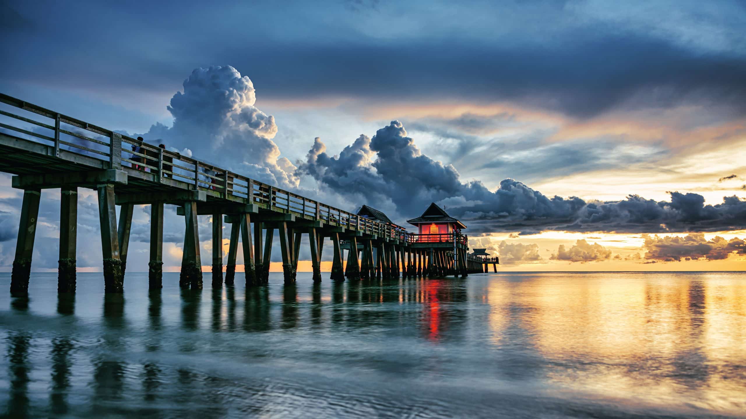 Sunset over the fishing pier and Gulf of Mexico in Naples, Florida.