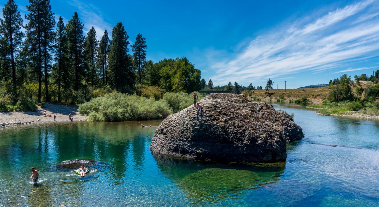 Summer fun in the clear-blue waters of the Spokane River. Washington, USA.
